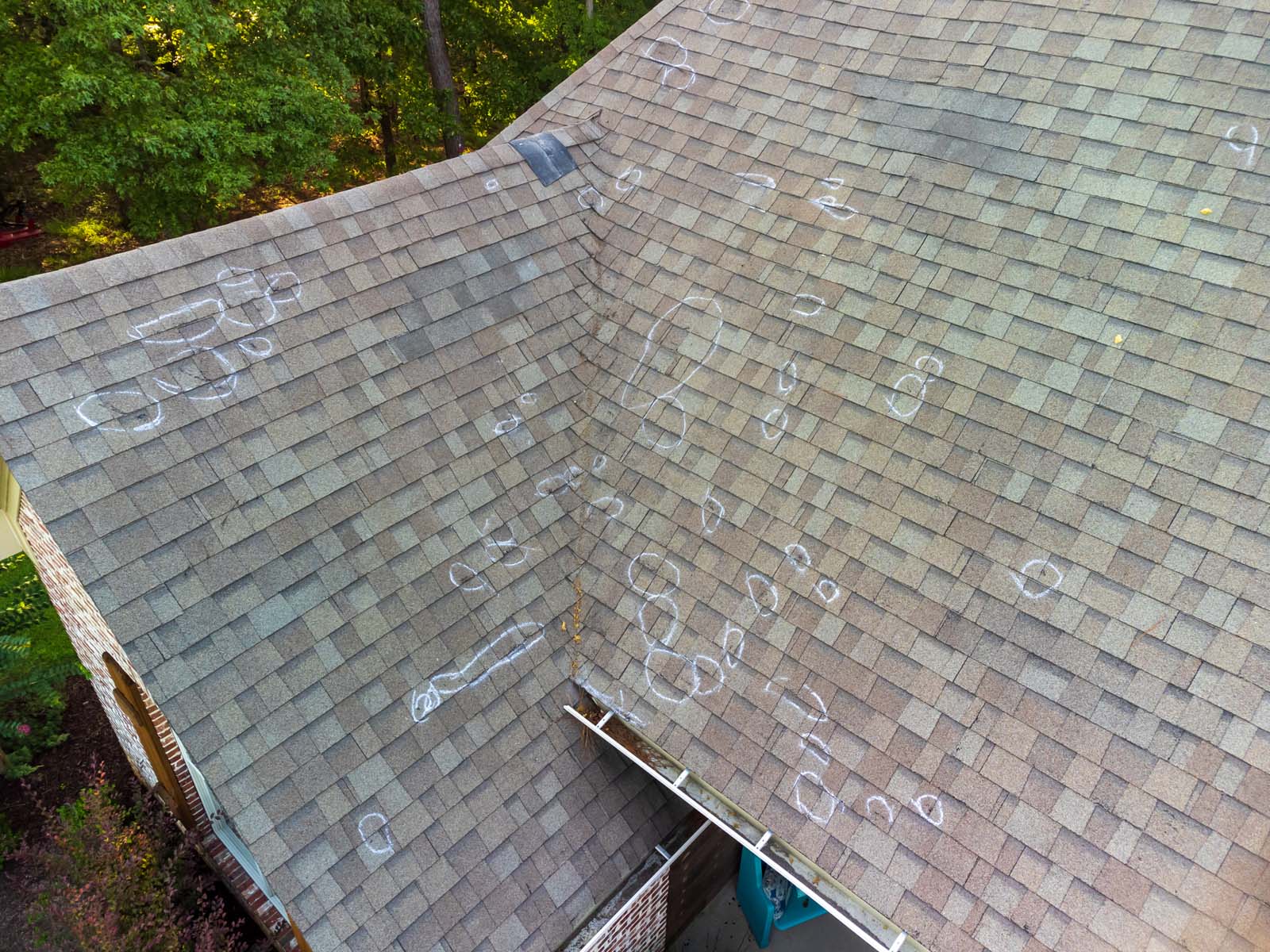 Roof with hail damage circled with chalk